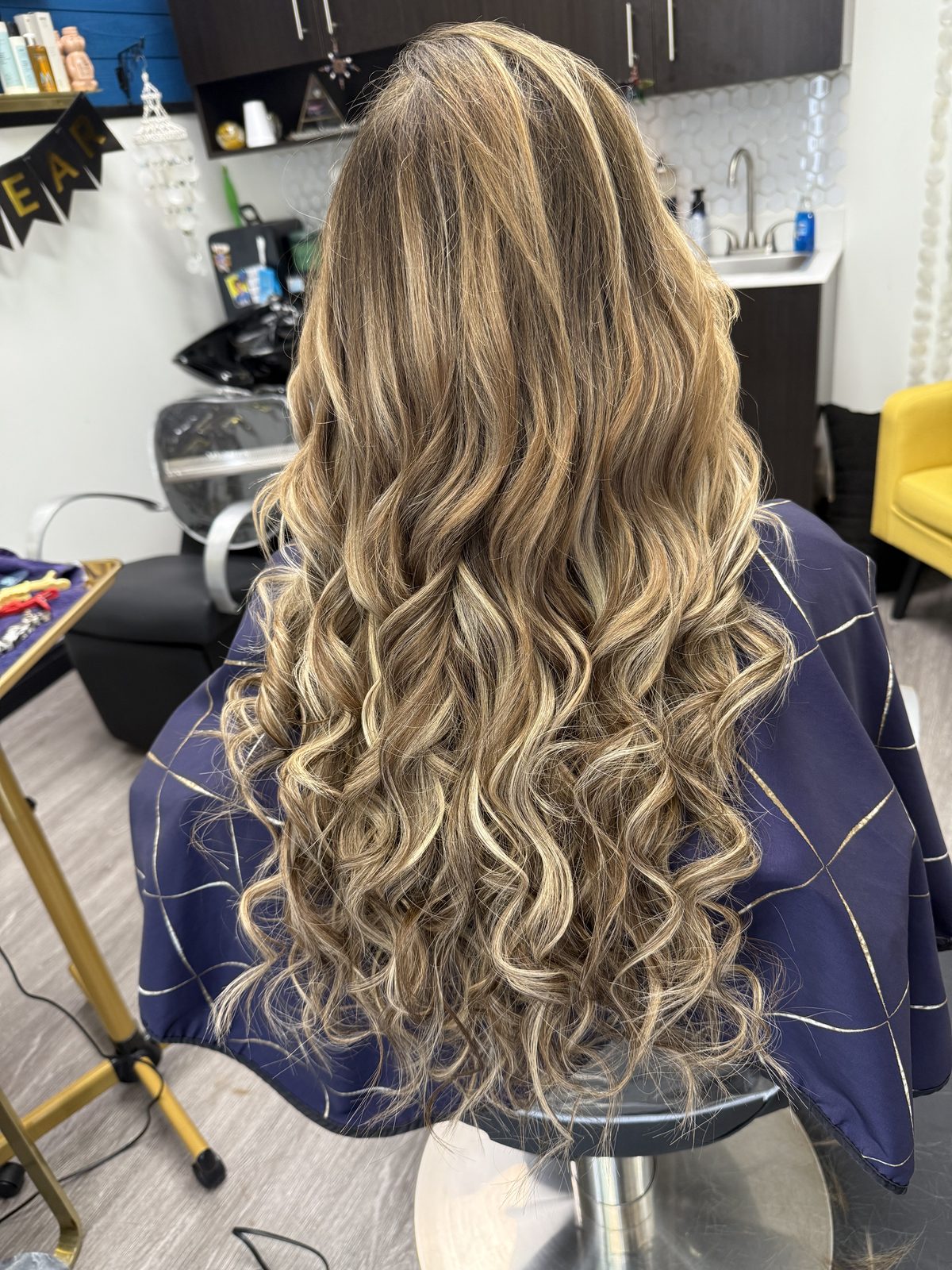 Blonde balayage waves in the studio chair
